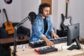 Young hispanic man composer composing song at music studio Royalty Free Stock Photo