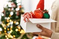 Young hispanic man decorating christmas tree at home Royalty Free Stock Photo