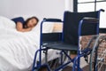 Young hispanic man disabled lying on bed sleeping at bedroom Royalty Free Stock Photo