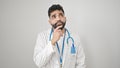 Young hispanic man doctor standing with doubt expression thinking over isolated white background Royalty Free Stock Photo