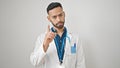 Young hispanic man doctor standing having an argument over isolated white background Royalty Free Stock Photo