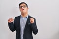 Young hispanic man with down syndrome wearing business style excited for success with arms raised and eyes closed celebrating Royalty Free Stock Photo