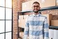 Young hispanic man ecommerce business worker smiling confident standing at office Royalty Free Stock Photo