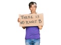 Young hispanic man holding there is no planet b banner covering mouth with hand, shocked and afraid for mistake Royalty Free Stock Photo