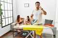 Young hispanic man ironing clothes at home mouth and lips shut as zip with fingers Royalty Free Stock Photo