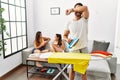 Young hispanic man ironing clothes at home smiling cheerful playing peek a boo with hands showing face Royalty Free Stock Photo