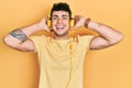 Young hispanic man listening to music using headphones smiling and laughing hard out loud because funny crazy joke Royalty Free Stock Photo