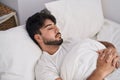 Young hispanic man lying on bed sleeping at bedroom Royalty Free Stock Photo