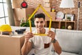 Young hispanic man moving to a new home smiling with a happy and cool smile on face Royalty Free Stock Photo