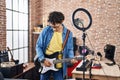 Young hispanic man musician playing electrical guitar recording video at music studio Royalty Free Stock Photo