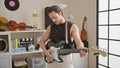 Young hispanic man musician playing electrical guitar with serious face at music studio Royalty Free Stock Photo