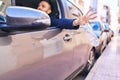 Young hispanic man opening car door at street Royalty Free Stock Photo