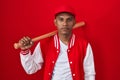 Young hispanic man playing baseball holding bat relaxed with serious expression on face Royalty Free Stock Photo