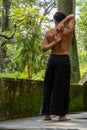 Young Hispanic man practicing Gomukhasana yoga pose in the forest in Mexico, Gualdajara Royalty Free Stock Photo