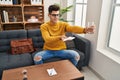 Young hispanic man psychologist counseling offer water and napkin at psychology center Royalty Free Stock Photo