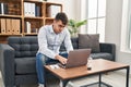 Young hispanic man psychologist using laptop at psychology clinic