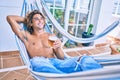 Young hispanic man relaxed drinking beer lying on the hammock at terrace Royalty Free Stock Photo