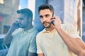 Young hispanic man with relaxed expresison talking on the smartphone at the city Royalty Free Stock Photo