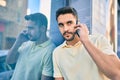 Young hispanic man with relaxed expresison talking on the smartphone at the city Royalty Free Stock Photo