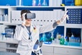 Young hispanic man scientist using virtual reality glasses at laboratory Royalty Free Stock Photo