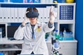 Young hispanic man scientist using virtual reality glasses at laboratory Royalty Free Stock Photo