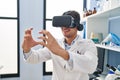 Young hispanic man scientist using virtual reality glasses at laboratory Royalty Free Stock Photo