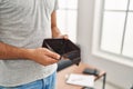 Young hispanic man showing empty wallet standing at home Royalty Free Stock Photo