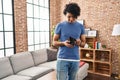 Young hispanic man showing empty wallet standing at home Royalty Free Stock Photo