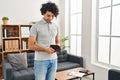 Young hispanic man showing empty wallet standing at home Royalty Free Stock Photo