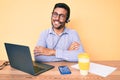 Young hispanic man sitting at the desk wearing operator headset at the call center office happy face smiling with crossed arms Royalty Free Stock Photo