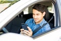 Young man using mobile phone in a car Royalty Free Stock Photo