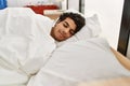 Young hispanic man sleeping on the bed at bedroom Royalty Free Stock Photo