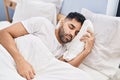 Young hispanic man sleeping on bed at bedroom Royalty Free Stock Photo