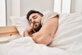 Young hispanic man sleeping on bed at bedroom Royalty Free Stock Photo