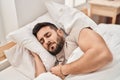 Young hispanic man sleeping on bed at bedroom Royalty Free Stock Photo