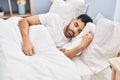 Young hispanic man sleeping on bed at bedroom Royalty Free Stock Photo