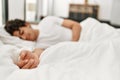 Young hispanic man sleeping lying on the bed at bedroom Royalty Free Stock Photo