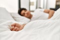 Young hispanic man sleeping lying on the bed at bedroom Royalty Free Stock Photo