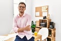 Young hispanic man smiling confident with arms crossed gesture at office Royalty Free Stock Photo