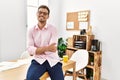 Young hispanic man smiling confident with arms crossed gesture at office Royalty Free Stock Photo