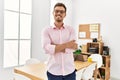 Young hispanic man smiling confident with arms crossed gesture at office Royalty Free Stock Photo