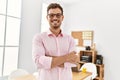 Young hispanic man smiling confident with arms crossed gesture at office Royalty Free Stock Photo