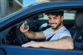 Young hispanic man smiling confident holding key of new car at street Royalty Free Stock Photo