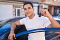 Young hispanic man smiling confident holding key of new car at street Royalty Free Stock Photo