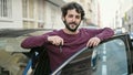 Young hispanic man smiling confident holding key of new car at street Royalty Free Stock Photo