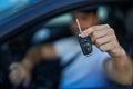 Young hispanic man smiling confident holding key of new car at street Royalty Free Stock Photo