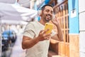 Young hispanic man smiling confident listening to music and dancing at street Royalty Free Stock Photo