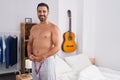 Young hispanic man smiling confident measuring waist at bedroom Royalty Free Stock Photo