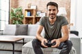 Young hispanic man smiling confident playing video game at home Royalty Free Stock Photo