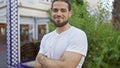 Young hispanic man smiling confident standing with arms crossed gesture at park Royalty Free Stock Photo